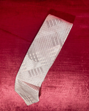 Patterned tie on a red textured fabric background