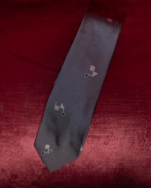 Black patterned tie on a red textured background