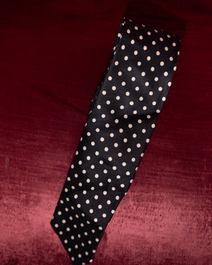 Black tie with white polka dots on a red background