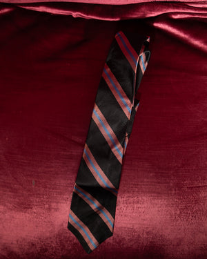 Striped tie on a red fabric background