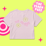 Light pink t-shirt with 'not straight' text and flowers on a green background with pink accents.