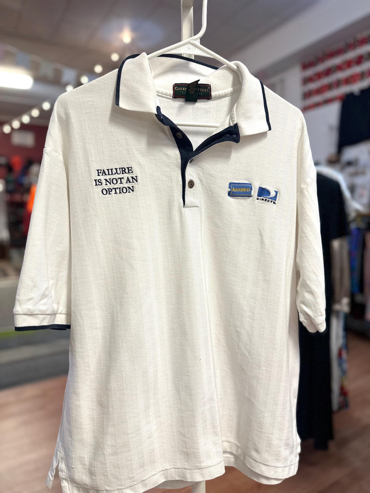 White polo shirt with text and logo on a hanger in a store setting