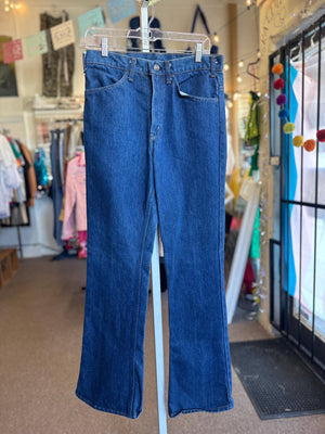 Blue jeans on a hanger in a store setting