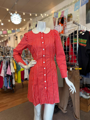 Red checkered dress on a mannequin in a store setting